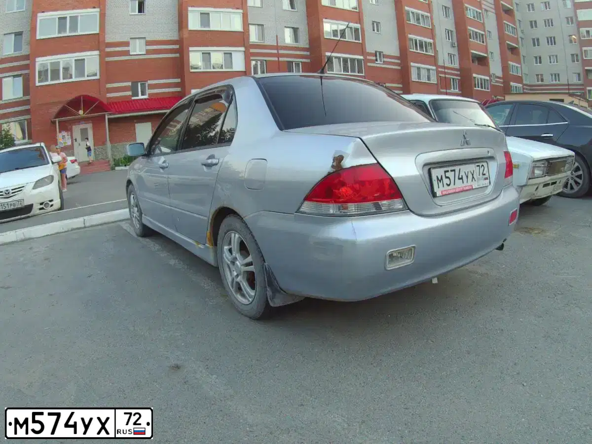 Фото автомобиля MITSUBISHI LANCER, 2004 — госномер М574УХ72. Цвет: СЕРЕБРИСТЫЙ