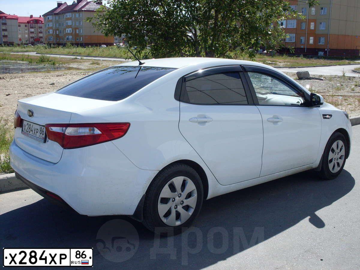 Фото автомобиля KIA RIO, 2012 — госномер Х284ХР86. Цвет: БЕЛЫЙ