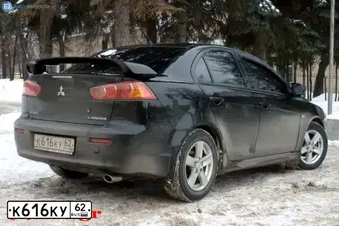 Фото автомобиля MITSUBISHI LANCER, 2007 — госномер Е154РУ62. Цвет: ЧЕРНЫЙ