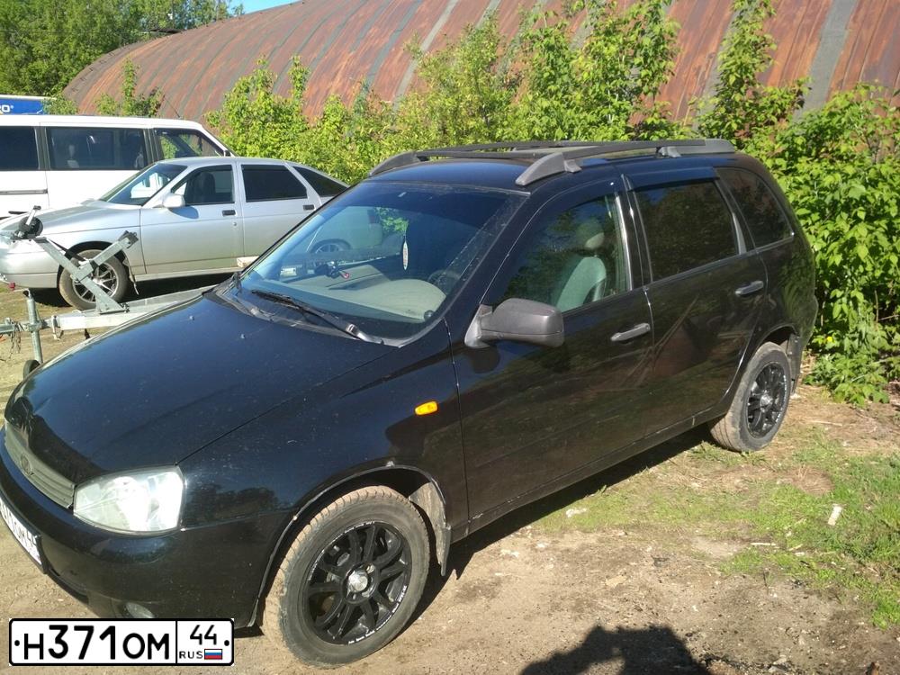 Фото автомобиля LADA KALINA, 2010 — госномер О255ХА44. Цвет: Сине-Черный