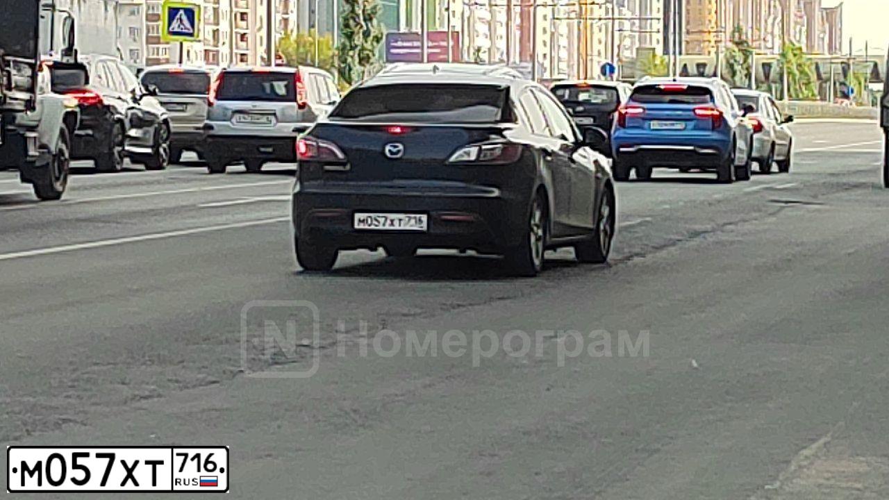 Фото автомобиля MAZDA 3, 2011 — госномер М057ХТ716. Цвет: ЧЕРНЫЙ