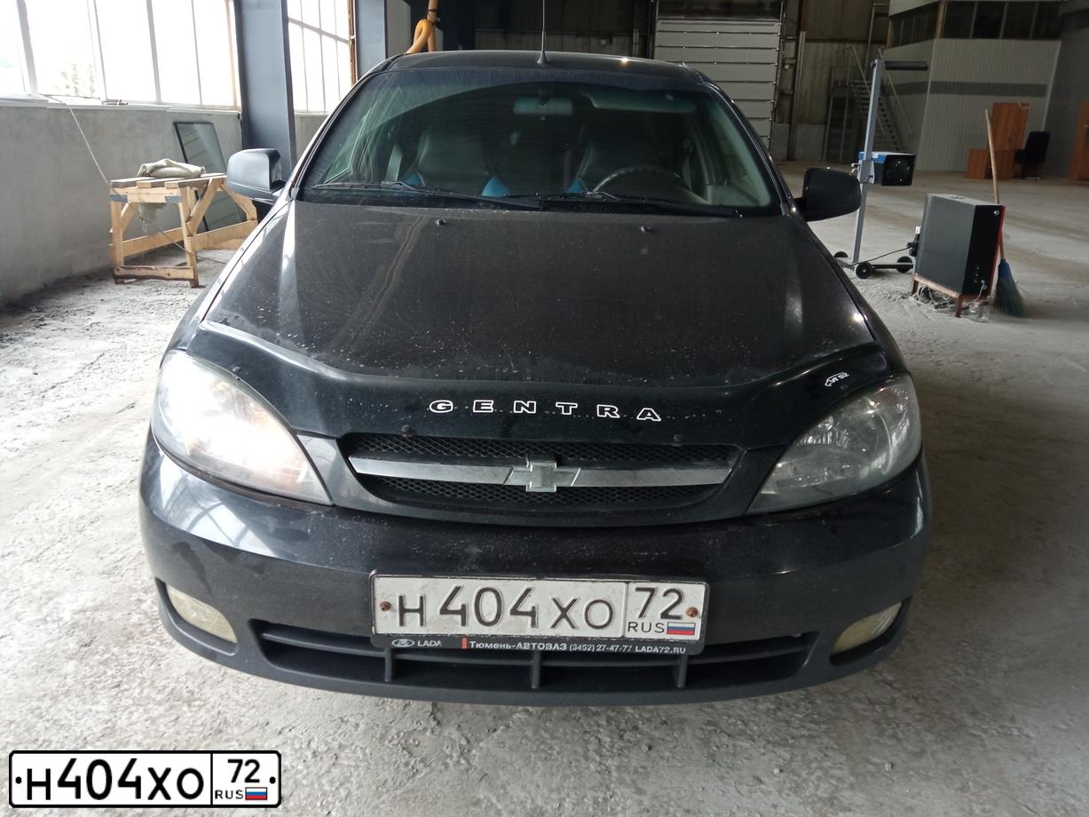 Фото автомобиля DAEWOO GENTRA, 2013 — госномер Е699ХВ774. Цвет: Бледно-Черный
