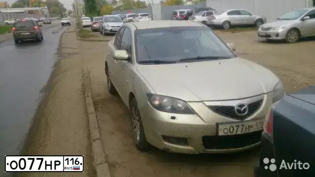 Фото автомобиля MAZDA 3, 2007 — госномер О077НР116. Цвет: СЕРО-ЗОЛОТИСТЫЙ