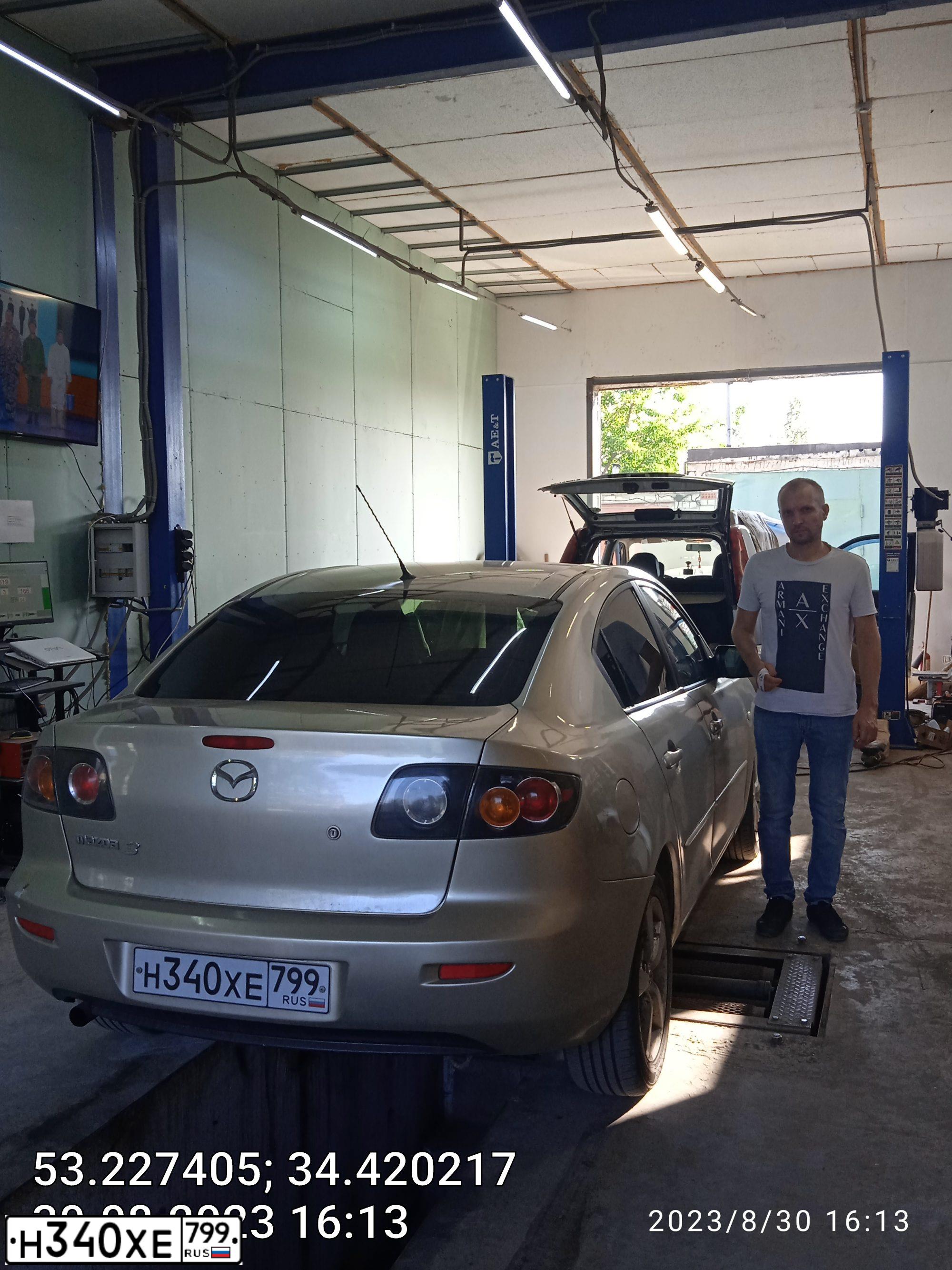 Фото автомобиля MAZDA 3, 2005 — госномер Т777МВ190. Цвет: СЕРО-ЗОЛОТИСТЫЙ