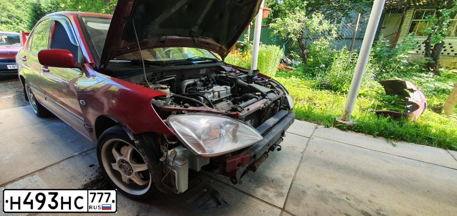 Фото автомобиля MITSUBISHI LANCER, 2004 — госномер Р974УА790. Цвет: Красный