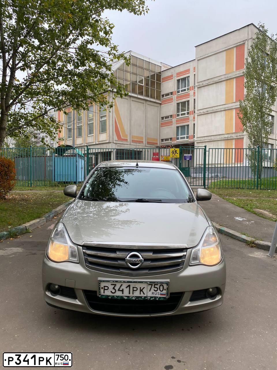 Фото автомобиля NISSAN ALMERA /AVTOVAZ/, 2013 — госномер Р590НН30. Цвет: СЕРО-БЕЖЕВЫЙ