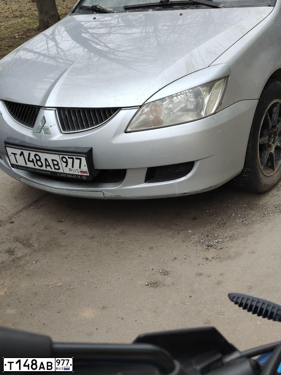 Фото автомобиля MITSUBISHI LANCER, 2004 — госномер Н596УС199. Цвет: СЕРЕБРИСТЫЙ