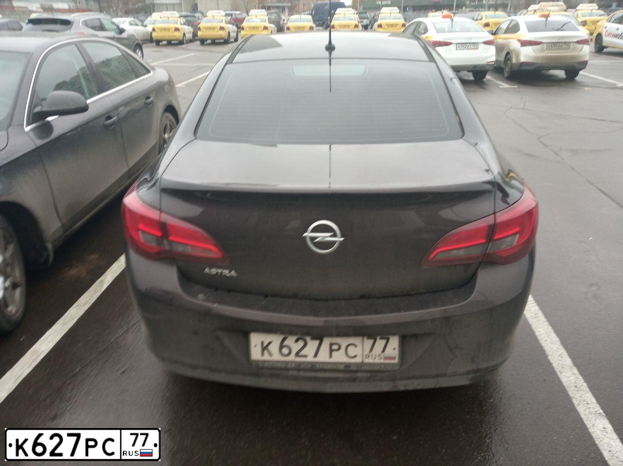 Фото автомобиля OPEL ASTRA, 2013 — госномер К627РС77. Цвет: Коричневый