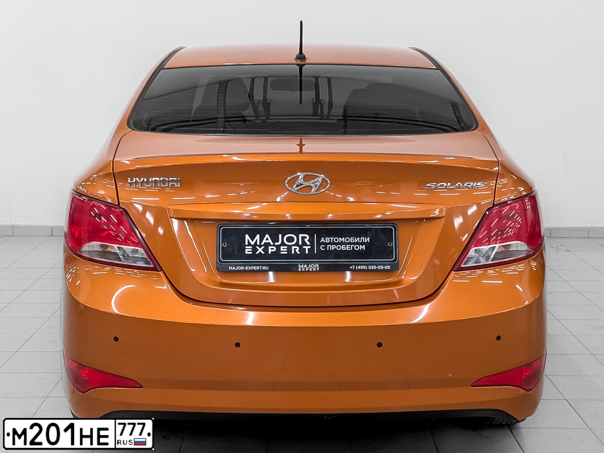 Фото автомобиля HYUNDAI SOLARIS, 2015 — госномер Т419КС977. Цвет: ОРАНЖЕВЫЙ