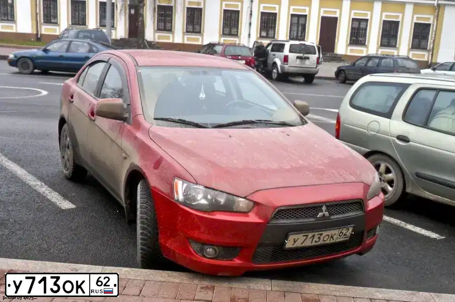Фото автомобиля MITSUBISHI LANCER, 2010 — госномер Х277ТЕ33. Цвет: Красный