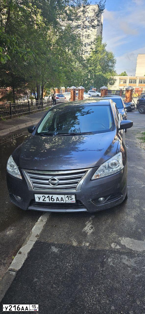 Фото автомобиля NISSAN SENTRALUCINO, 2015 — госномер У332УА716. Цвет: ТЕМНО-СЕРЫЙ