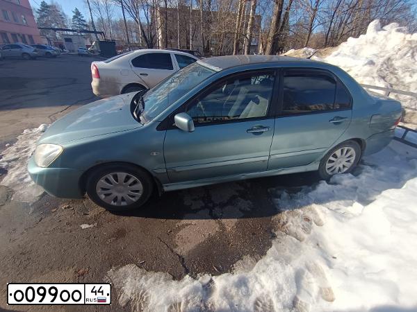 Фото автомобиля MITSUBISHI LANCER, 2006 — госномер О099ОО44. Цвет: СВЕТЛО-СЕРО-ЗЕЛЕНЫЙ