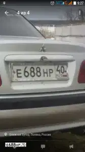 Фото автомобиля MITSUBISHI CARISMA, 2002 — госномер Е688НО40. Цвет: СВЕТЛО-СЕРЫЙ