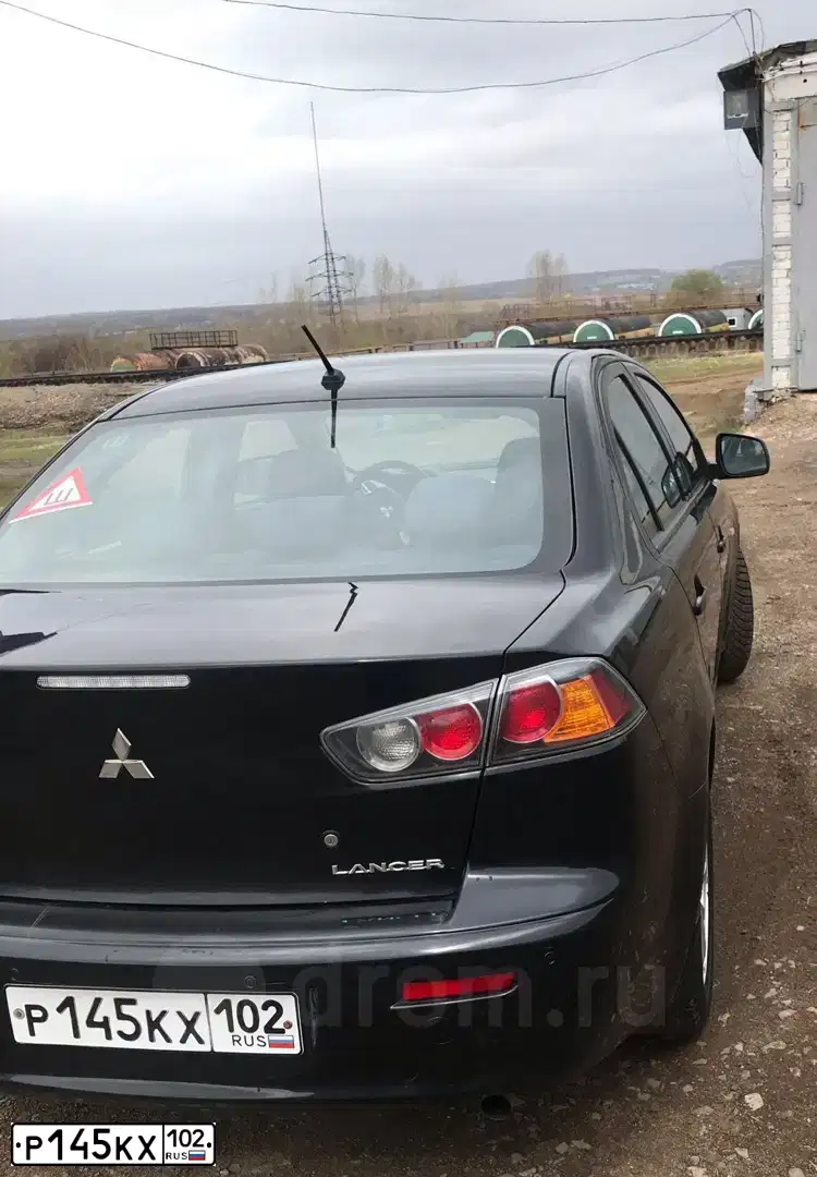 Фото автомобиля MITSUBISHI LANCER, 2013 — госномер Р145КХ102. Цвет: ЧЕРНЫЙ
