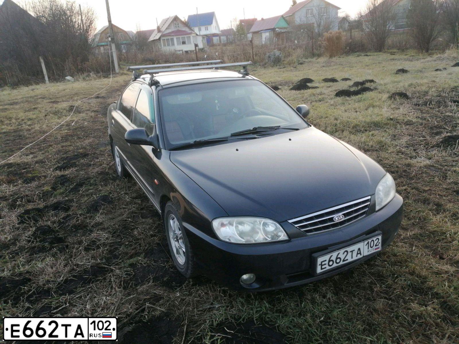 Фото автомобиля KIA SPECTRA, 2008 — госномер Е144МС702. Цвет: ЧЕРНЫЙ ЖЕМЧУГ
