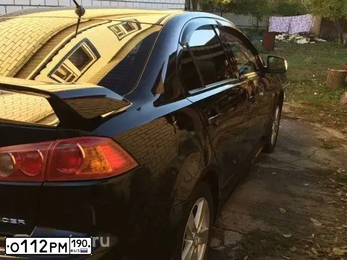 Фото автомобиля MITSUBISHI LANCER, 2007 — госномер Е577ВН11. Цвет: ЧЕРНЫЙ