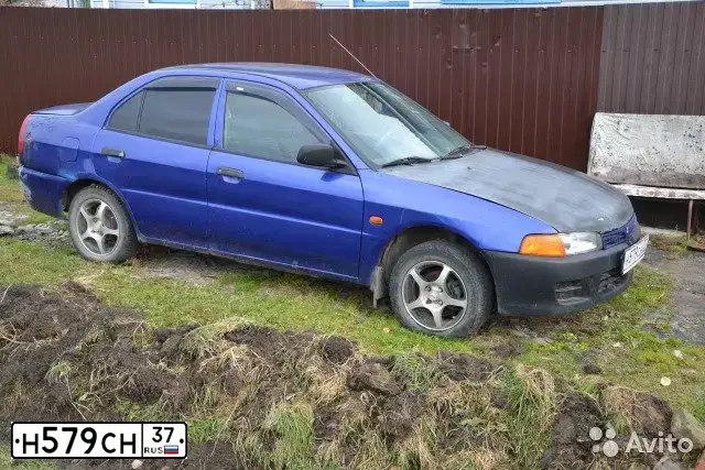 Фото автомобиля MITSUBISHI LANCER, 1997 — госномер Н579СН37. Цвет: ФИОЛЕТОВЫЙ
