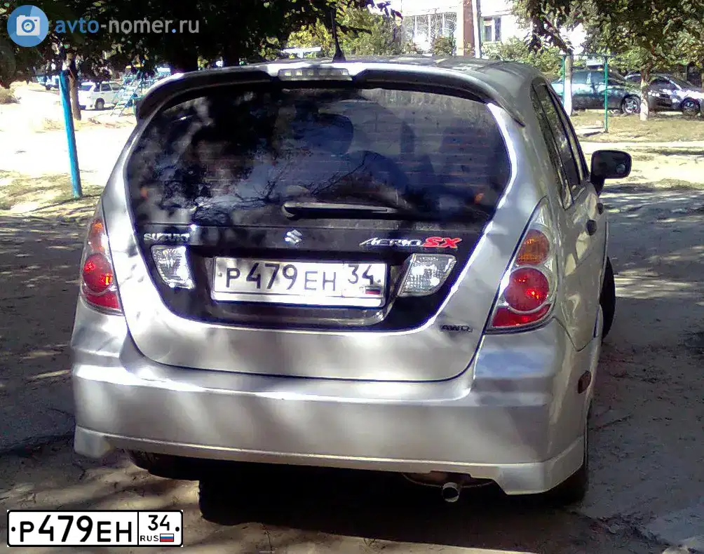 Фото автомобиля SUZUKI AERIO, 2005 — госномер К201УА134. Цвет: Серебристый