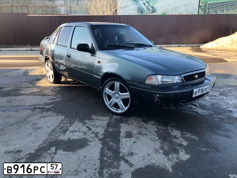 Фото автомобиля DAEWOO NEXIA, 1999 — госномер В103РР57. Цвет: СЕРО-ЗЕЛЕНЫЙ