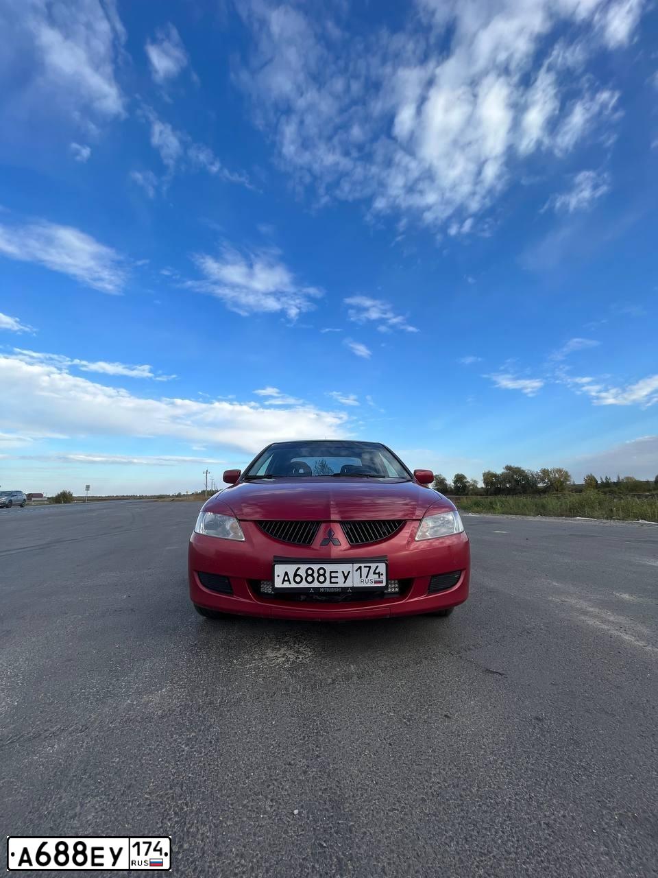 Фото автомобиля MITSUBISHI LANCER, 2004 — госномер Х140ЕР72. Цвет: Красный