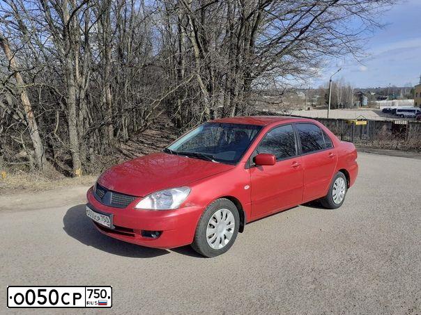 Фото автомобиля MITSUBISHI LANCER, 2005 — госномер Е556ВС57. Цвет: Красный