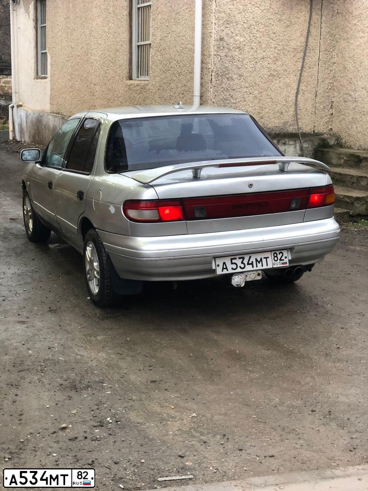 Фото автомобиля КИА СЕФИЯ, 1993 — госномер А534МТ82. Цвет: Серый