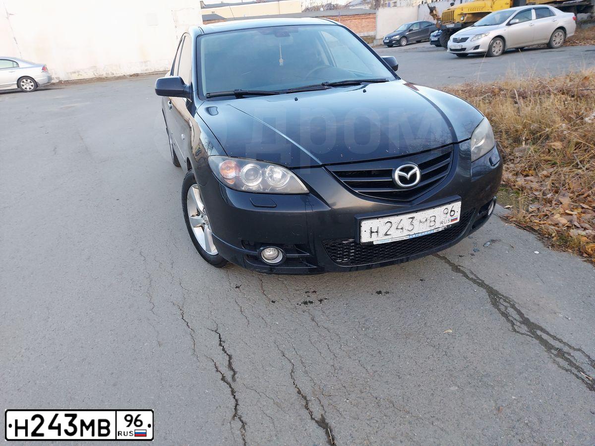 Фото автомобиля MAZDA 3, 2005 — госномер Е220ЕК774. Цвет: ЧЕРНЫЙ