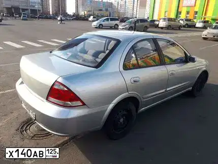 Фото автомобиля NISSAN ALMERA, 2010 — госномер Х140АВ125. Цвет: СЕРЫЙ