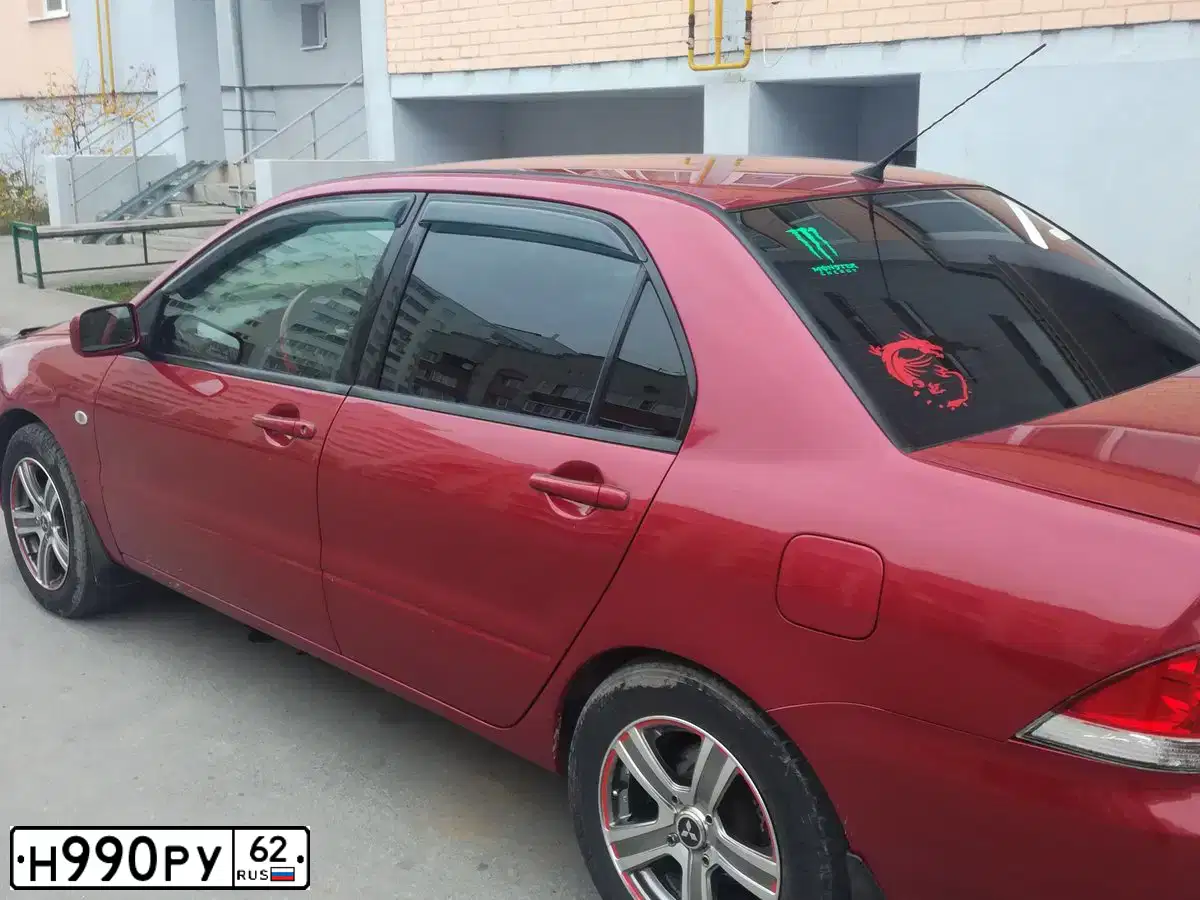 Фото автомобиля MITSUBISHI LANCER, 2004 — госномер Н990РУ62. Цвет: Красный