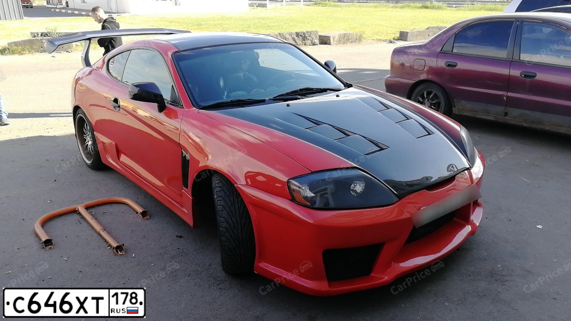 Фото автомобиля HYUNDAI TIBURON, 2003 — госномер С646ХТ178. Цвет: ОРАНЖЕВО-ЧЕРНЫЙ