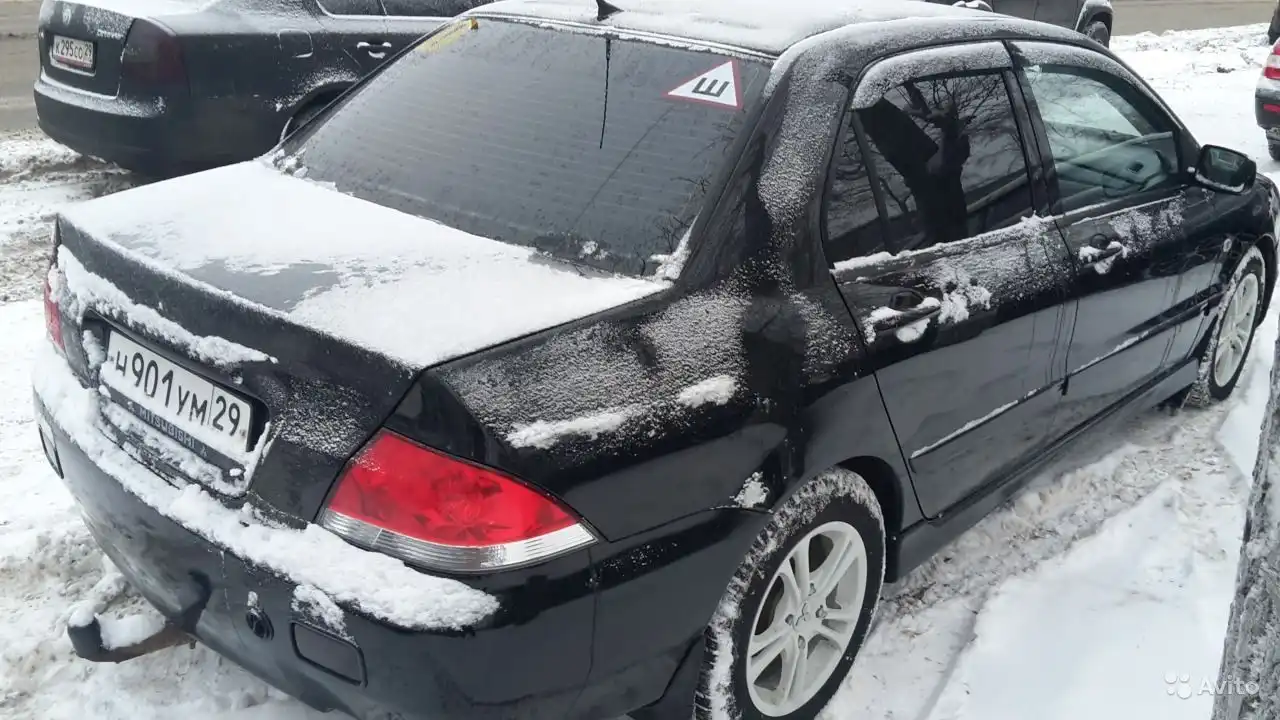 Фото автомобиля MITSUBISHI LANCER, 2004 — госномер Н901УМ29. Цвет: ЧЕРНЫЙ