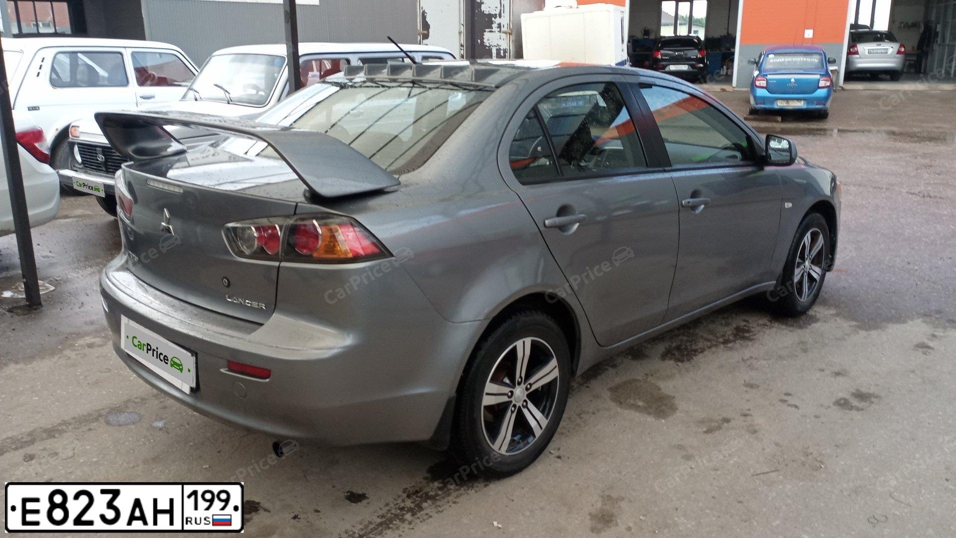 Фото автомобиля MITSUBISHI LANCER, 2012 — госномер Е021РМ797. Цвет: СЕРЫЙ