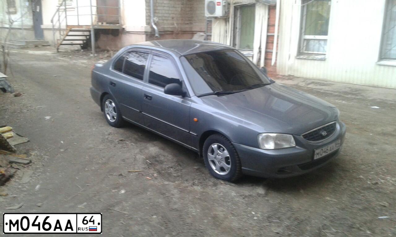Фото автомобиля TAGAZ ACCENT, 2005 — госномер М046АА64. Цвет: СЕРЫЙ