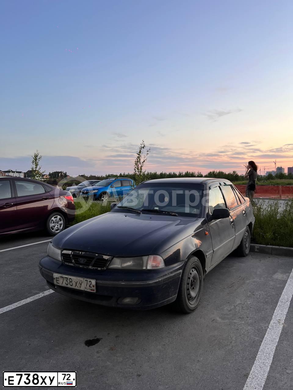 Фото автомобиля DAEWOO NEXIA, 2007 — госномер Е738ХУ72. Цвет: ЧЕРНО-СИНИЙ