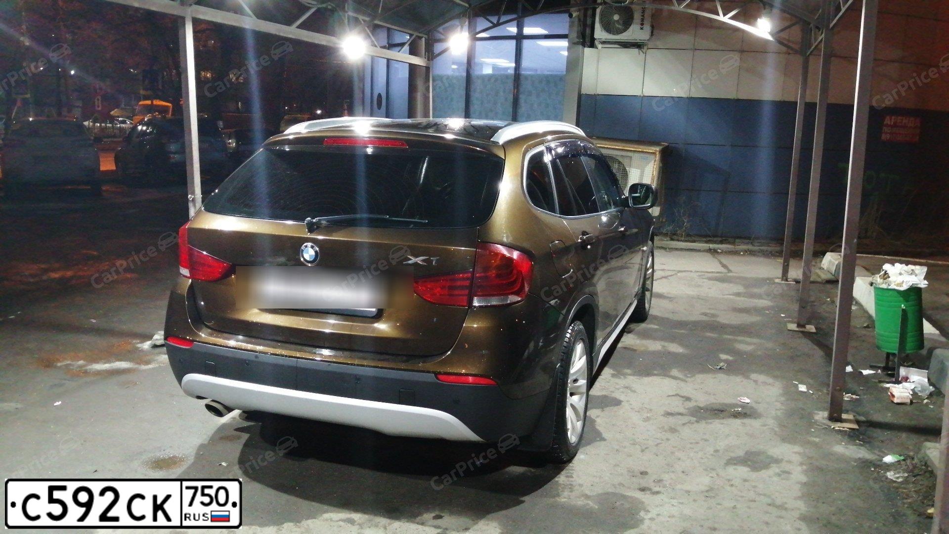 Фото автомобиля BMW X1, 2012 — госномер К002ВО152. Цвет: Коричневый