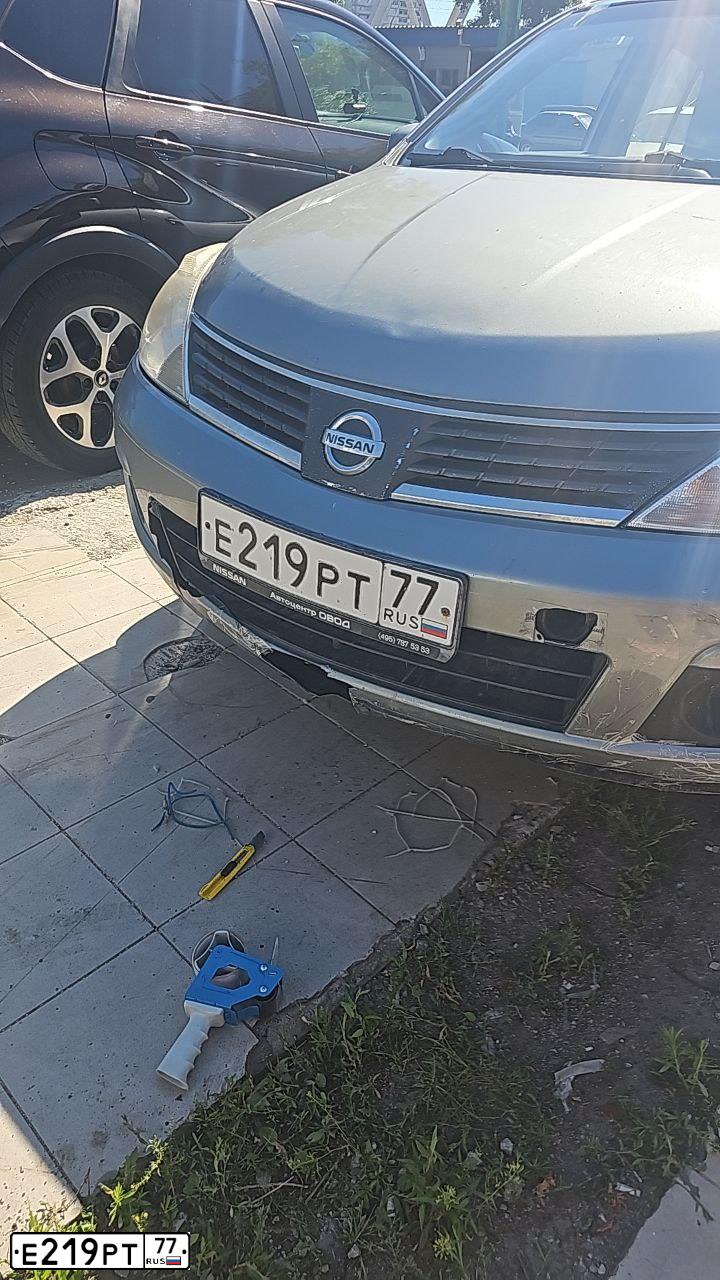 Фото автомобиля NISSAN TIIDA, 2013 — госномер Е219РТ77. Цвет: СЕРЫЙ