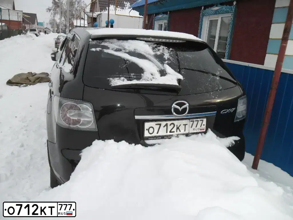 Фото автомобиля MAZDA CX-7, 2010 — госномер О712КТ777. Цвет: ЧЕРНЫЙ