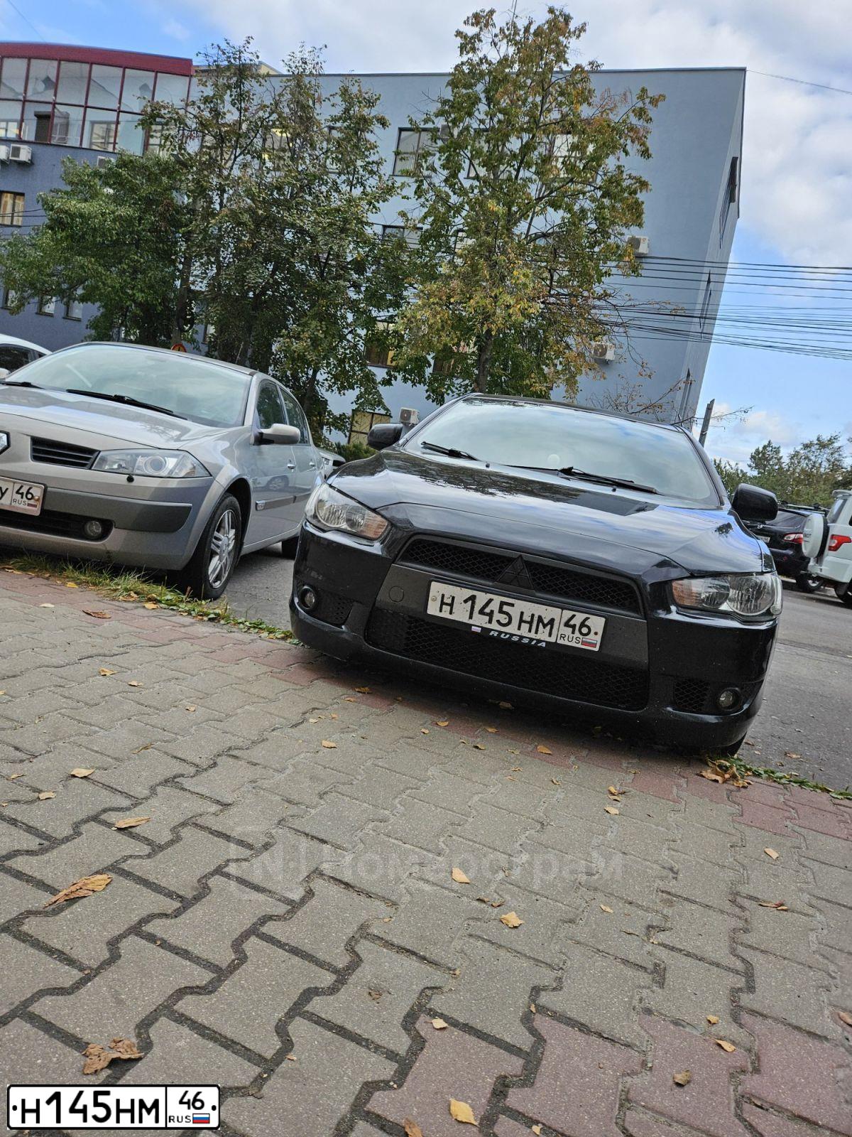 Фото автомобиля MITSUBISHI LANCER, 2008 — госномер Н145НМ46. Цвет: ЧЕРНЫЙ