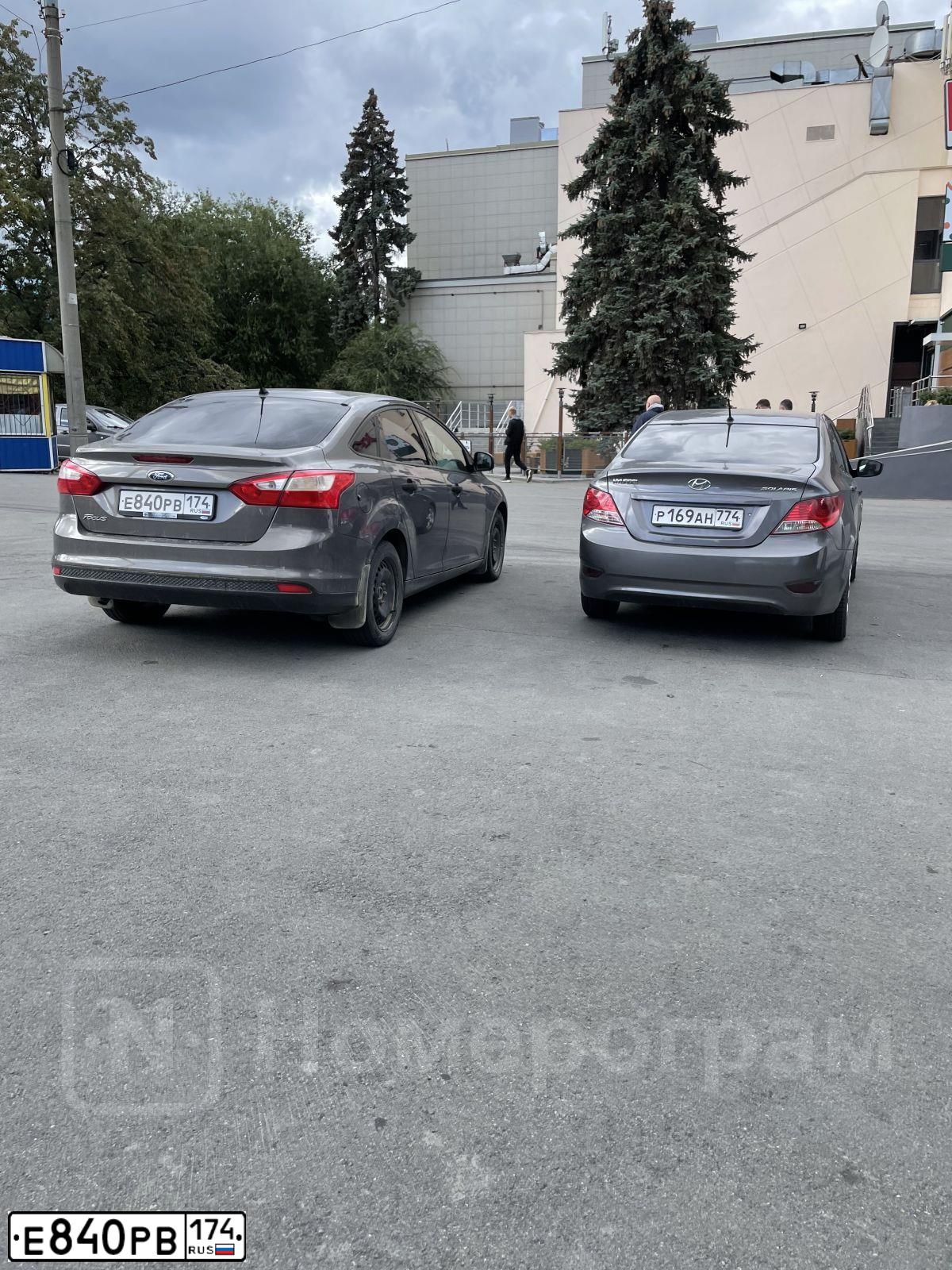 Фото автомобиля FORD FOCUS, 2012 — госномер Е840РВ174. Цвет: СЕРО-КОРИЧНЕВЫЙ