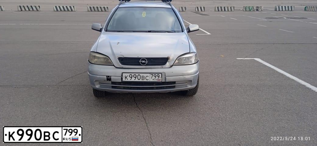 Фото автомобиля OPEL ASTRA, 2002 — госномер М210РУ18. Цвет: СВЕТЛО-СЕРЫЙ