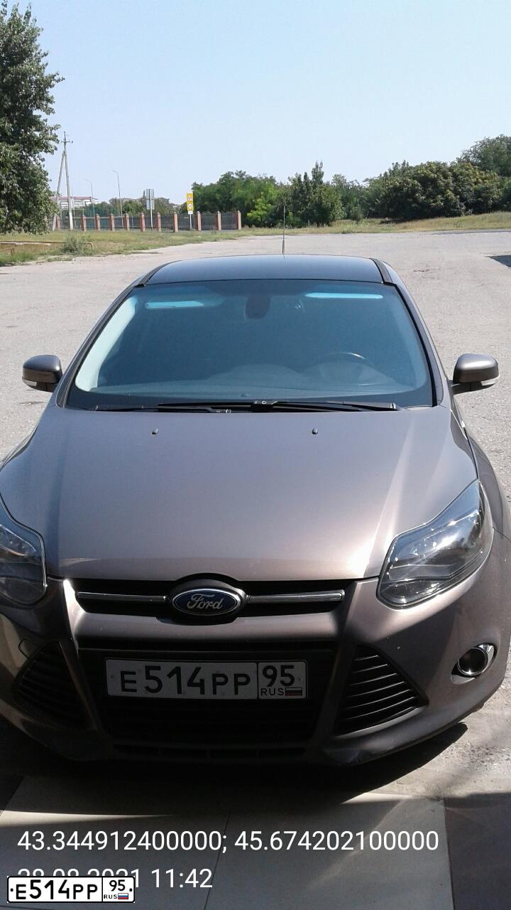 Фото автомобиля FORD FOCUS, 2012 — госномер Т091УР197. Цвет: Коричневый