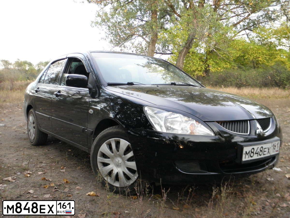 Фото автомобиля MITSUBISHI LANCER, 2004 — госномер Т121РВ161. Цвет: ЧЕРНЫЙ