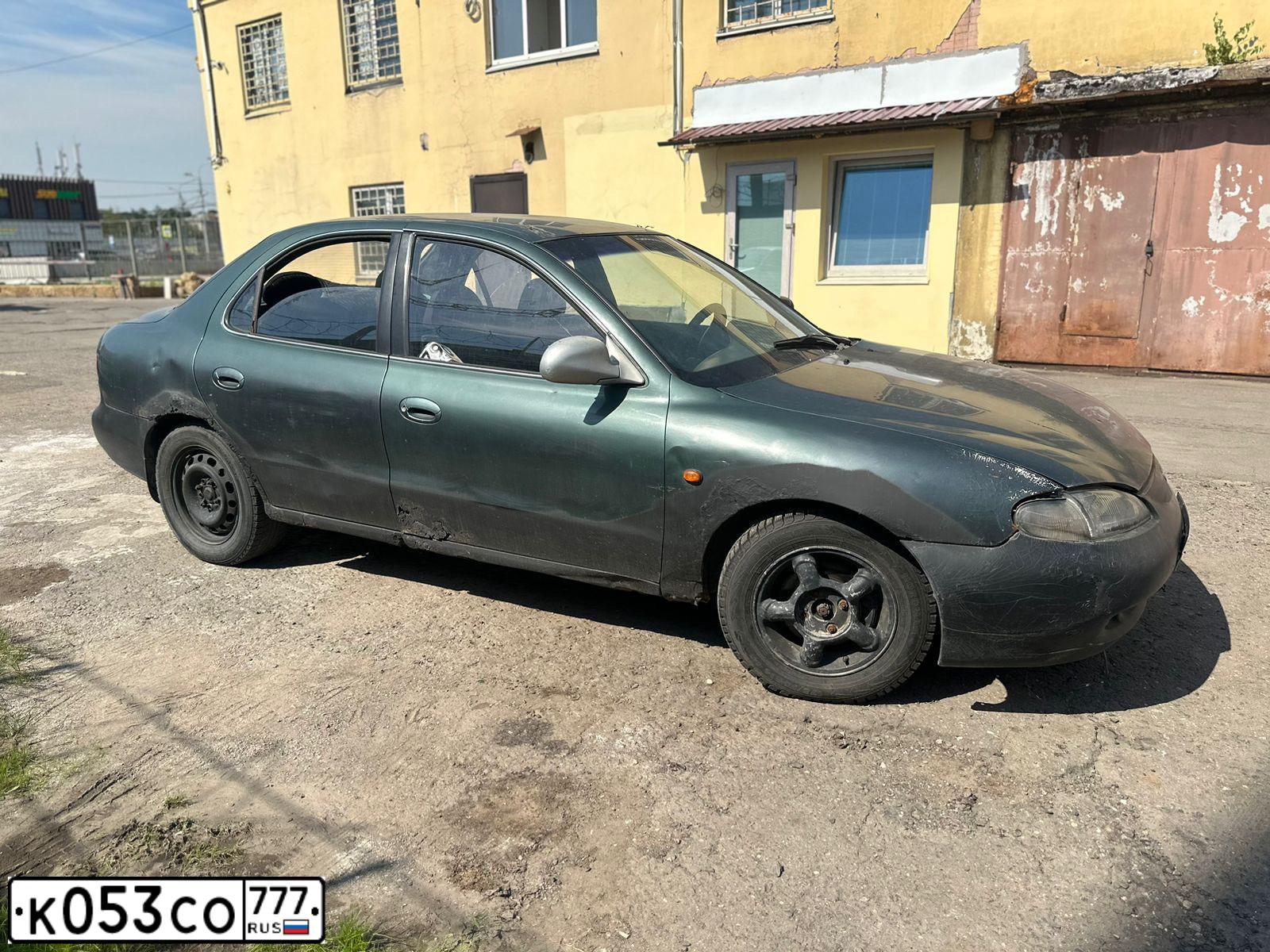 Фото автомобиля HYUNDAI LANTRA, 1997 — госномер О787ХУ790. Цвет: ОЛИВКОВЫЙ