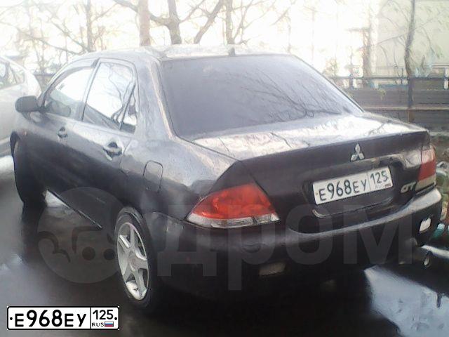 Фото автомобиля MITSUBISHI LANCER, 2006 — госномер Е968ЕУ125. Цвет: ЧЕРНЫЙ