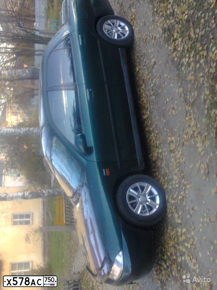 Фото автомобиля MITSUBISHI CARISMA, 1998 — госномер Е153РЕ36. Цвет: ЗЕЛЕНЫЙ