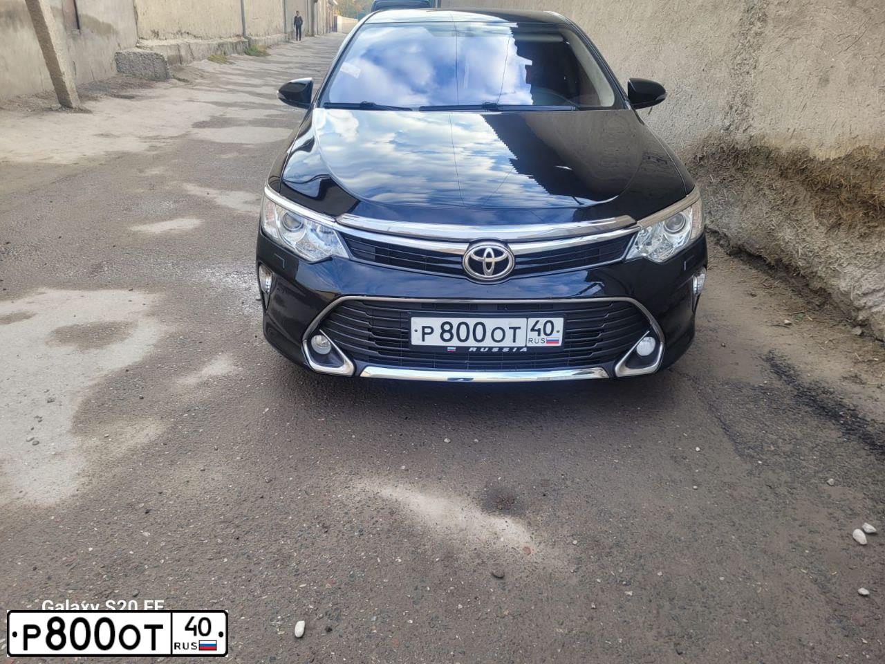 Фото автомобиля TOYOTA ТОЙОТА КАМРИ, 2016 — госномер Е980КР777. Цвет: ЧЕРНЫЙ МЕТАЛЛИК
