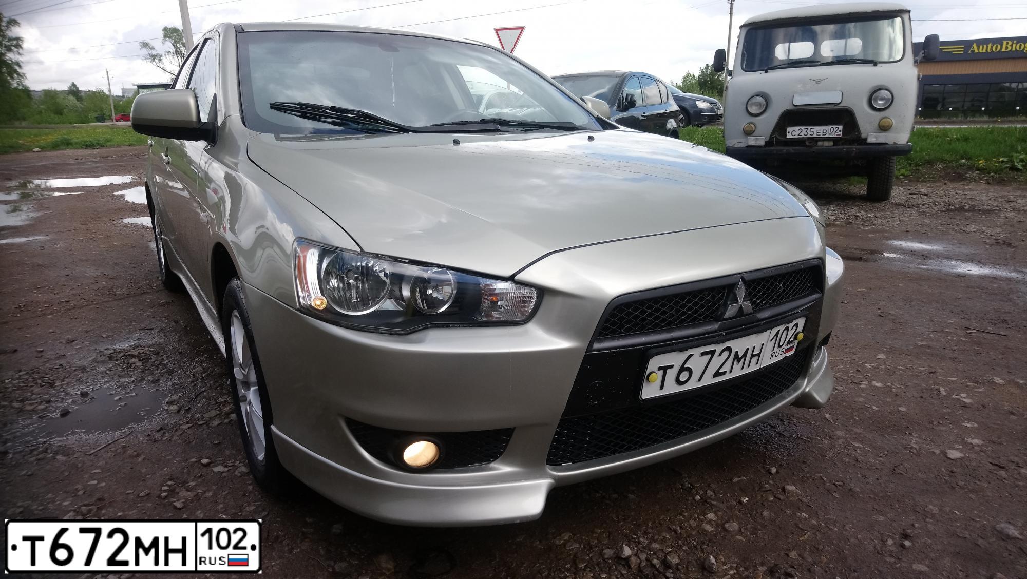 Фото автомобиля MITSUBISHI LANCER, 2007 — госномер Е323ВН702. Цвет: БЕЖЕВЫЙ