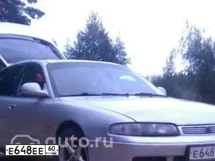 Фото автомобиля MAZDA 626, 1995 — госномер Е648ЕЕ60. Цвет: Серебристый