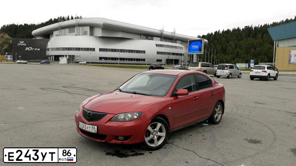 Фото автомобиля MAZDA 3, 2005 — госномер В631ОМ186. Цвет: ЯРКО-КРАСНЫЙ
