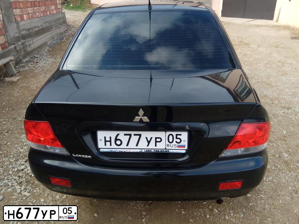 Фото автомобиля MITSUBISHI LANCER, 2007 — госномер Н677УР05. Цвет: ЧЕРНЫЙ